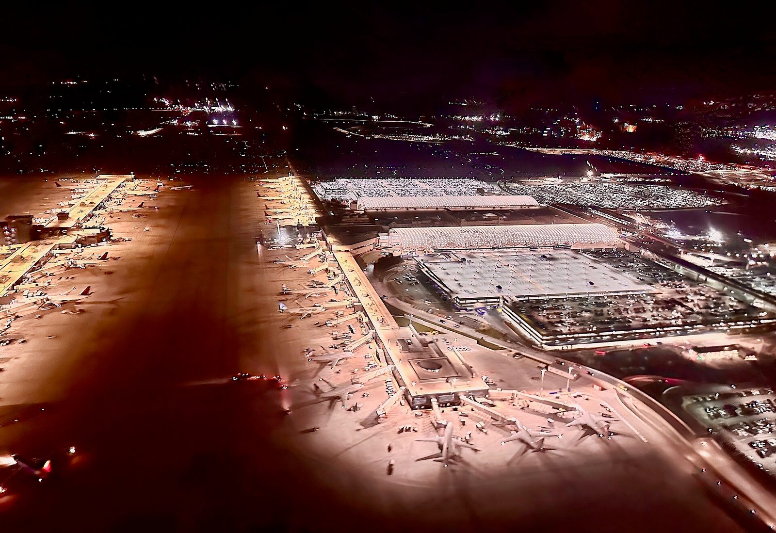 aerial night view of Hartsfield-Jackson airport, terminals and parked planes, Atlanta