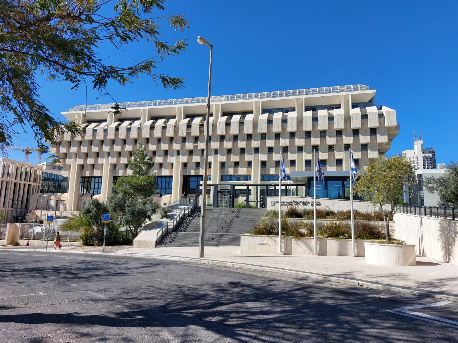 Large stone office building, wide steps, flagpoles and trees, Jerusalem