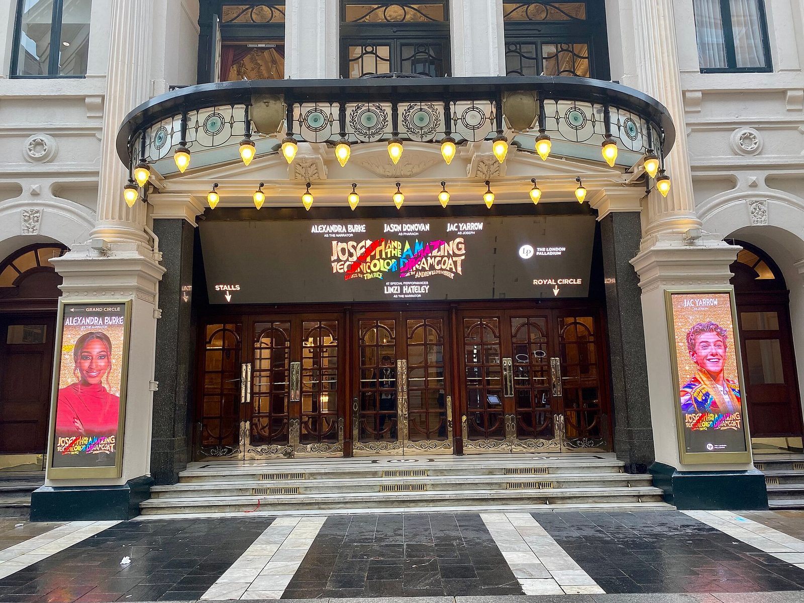 London Palladium entrance doors, lit marquee, digital posters, London Palladium