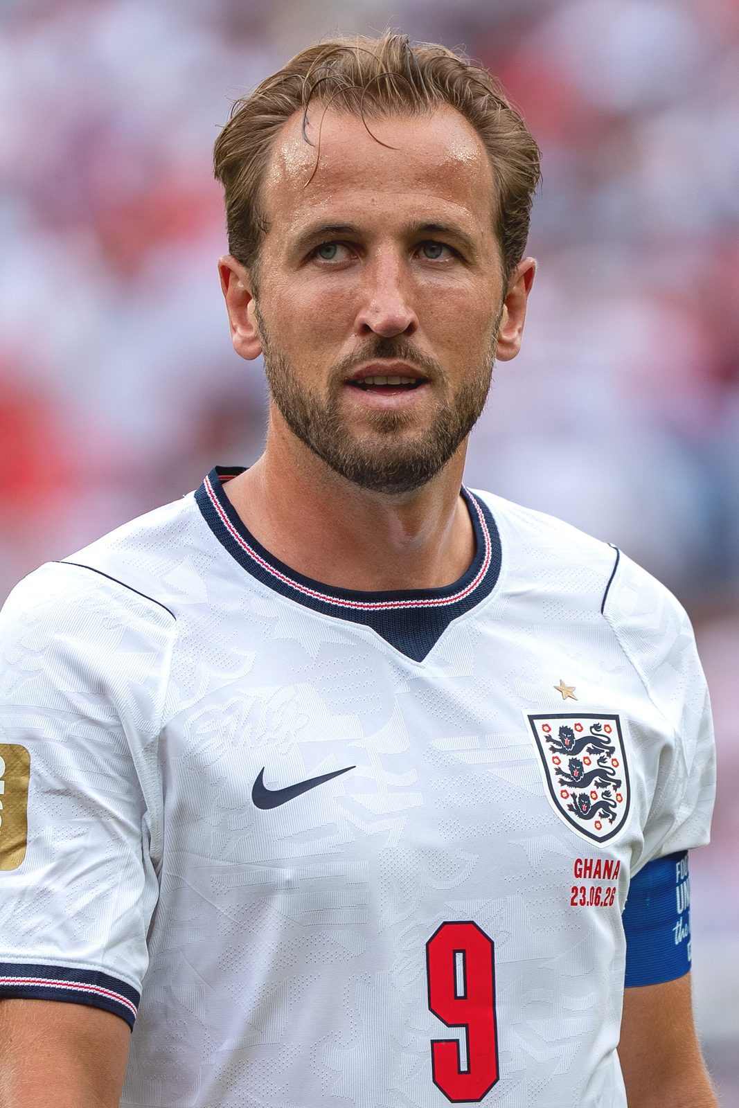 Close-up of male footballer in white England shirt, number 9