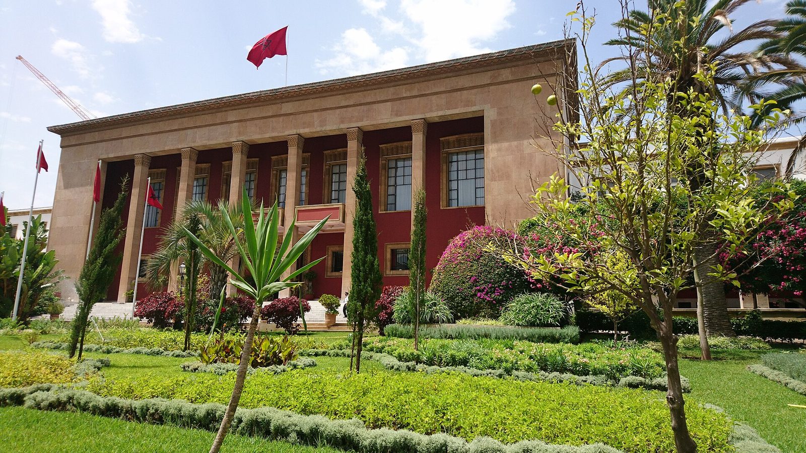 Parliament building with landscaped garden, flag flying overhead, Rabat