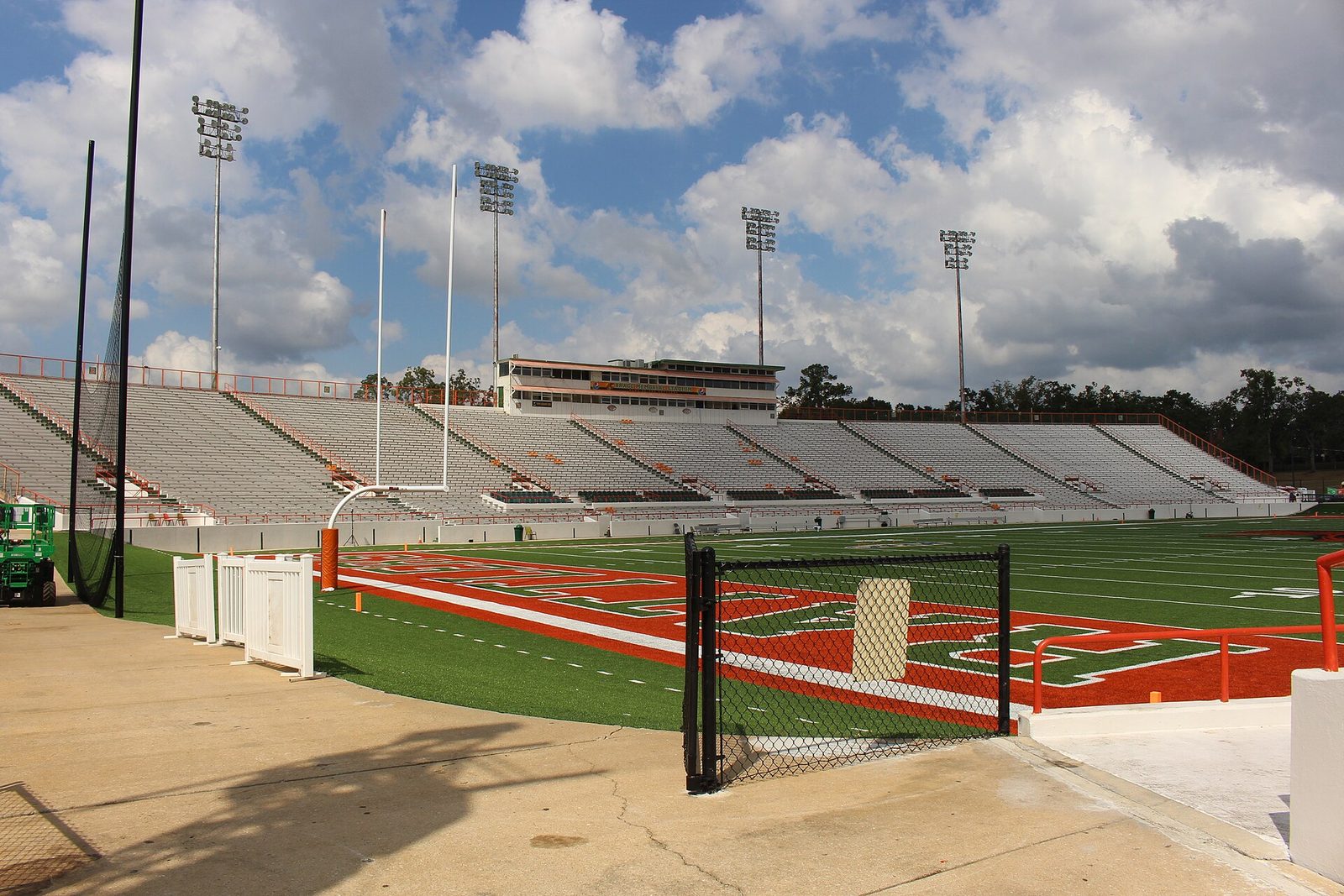Interior view of football field, goalposts, empty stands, scoreboard beyond, Bragg Memorial Stadium
