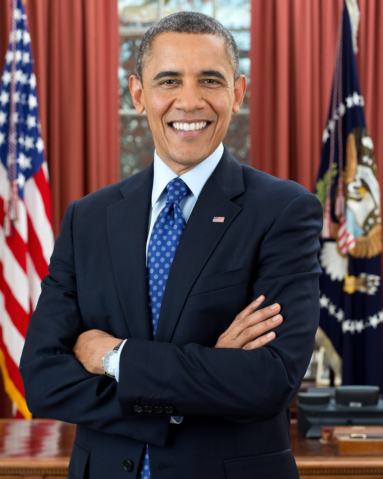 smiling man in suit, official portrait, flags and presidential seal behind