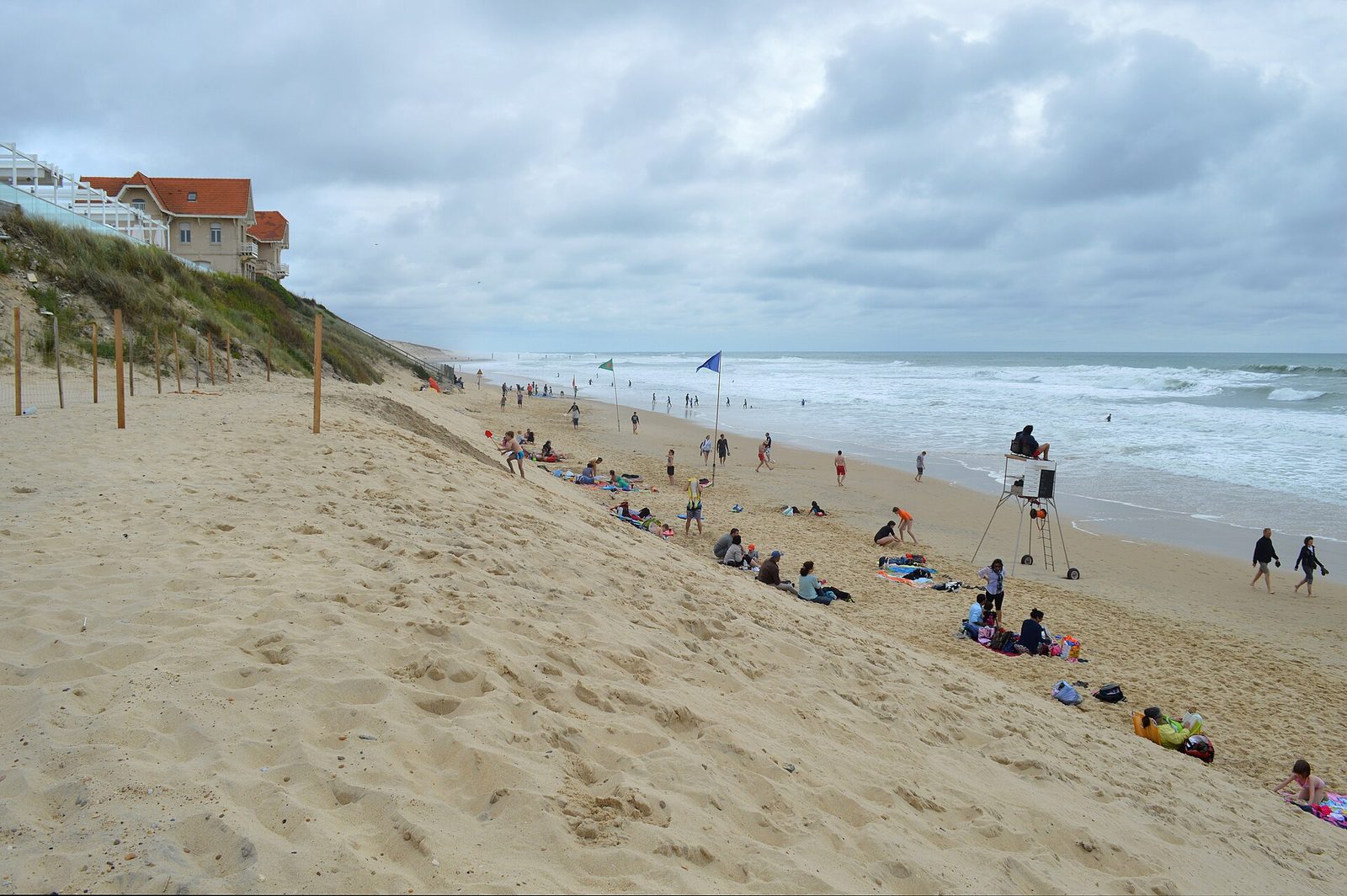 sandy beach with people, dunes and a lifeguard chair, Biscarrosse
