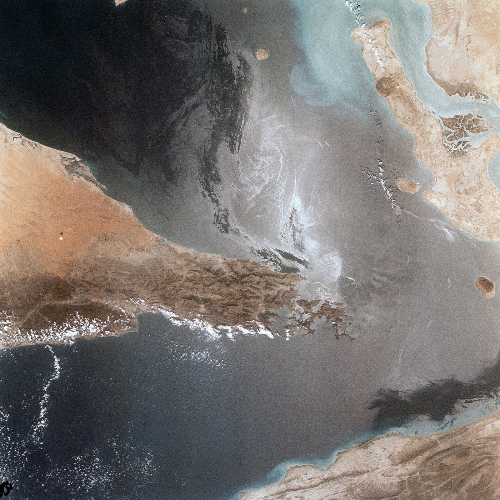 satellite photo showing narrow strait, coastlines and multiple ship wakes, Strait of Hormuz