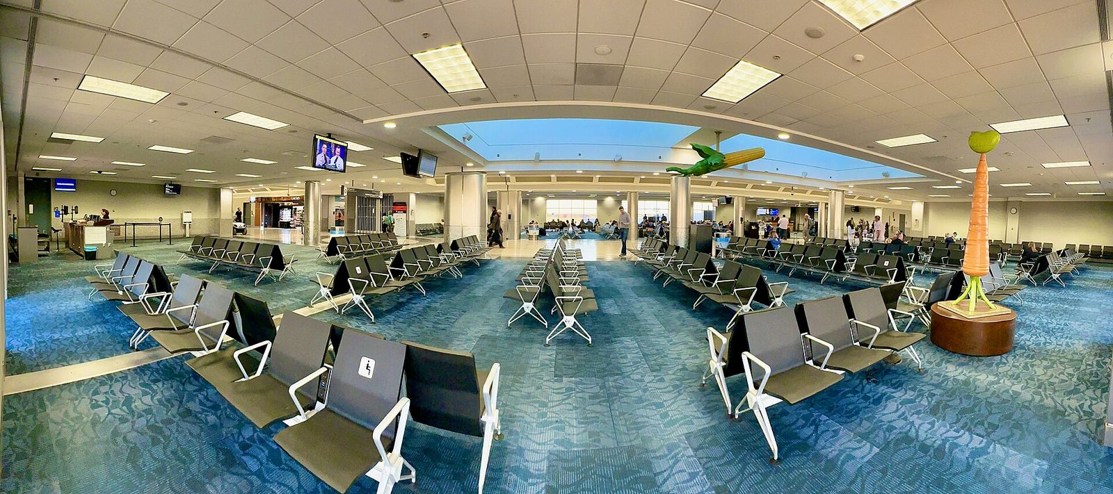 terminal interior with rows of empty gate seats, blue carpet and pillars, Atlanta