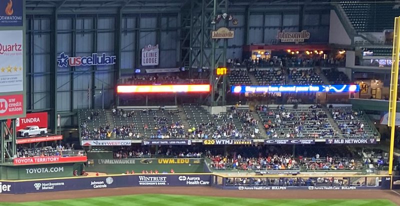 Stadium interior seating and scoreboard area, pitch clock visible, American Family Field