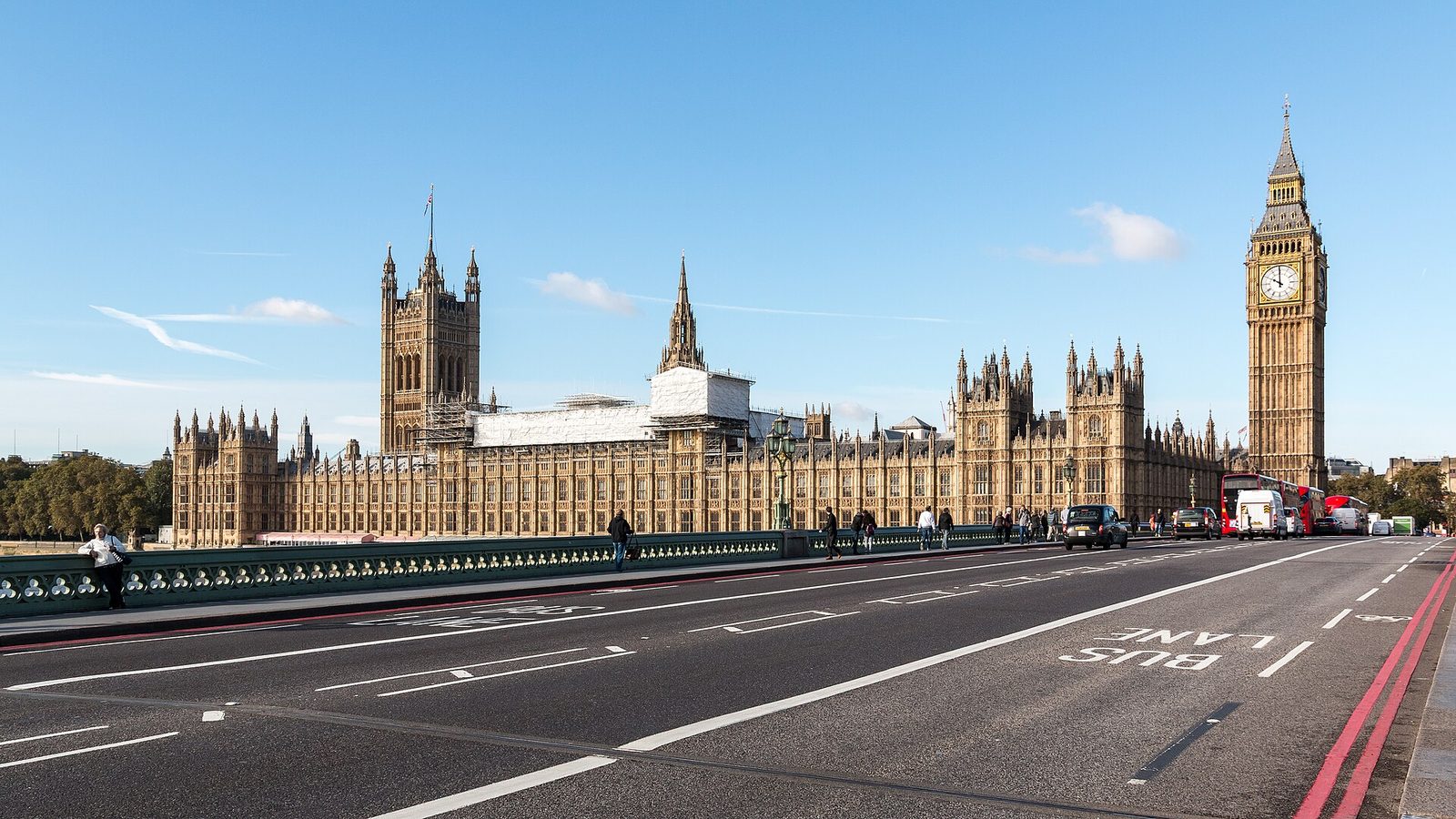 Large Gothic riverside parliamentary building, road and bridge foreground, London