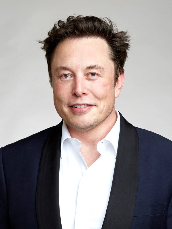 Smiling half-body portrait of a man in a dark jacket