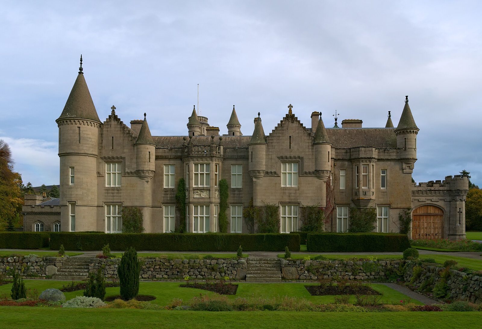 Front facade of a stone castle, formal gardens and terraced beds in, Balmoral Castle