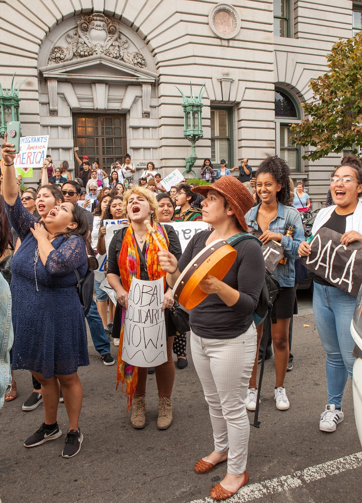 Crowd of protesters in front of a large classical stone courthouse, San Francisco